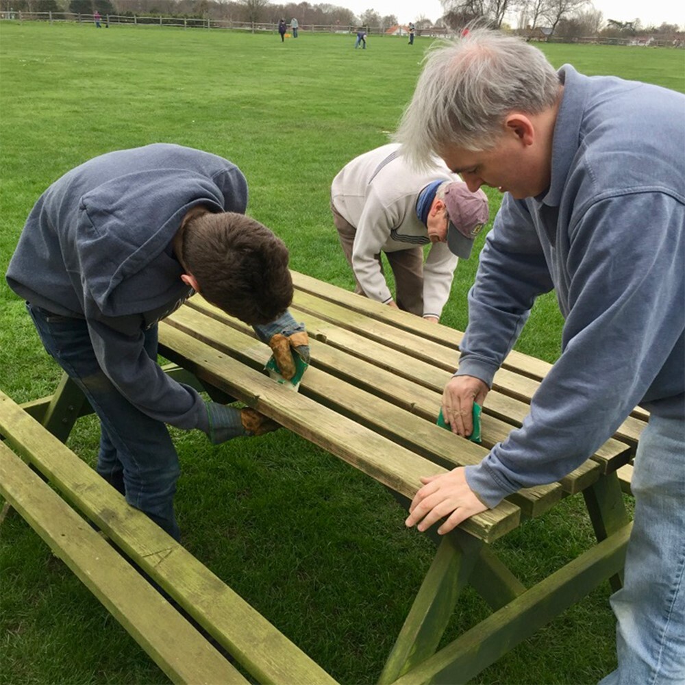 Volunteers repairing a bench